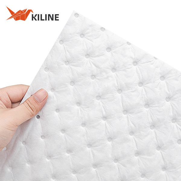 Heavyweight white polypropylene oil absorbent mats in industrial setting