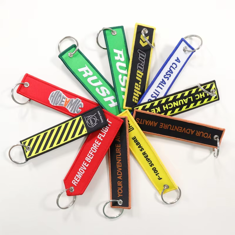 China Flight Custom logo Key Tag Embroidered Key Ring Custom Jet Tag Key Chains Fabric Woven Brand Label Woven Keychain Wholesale on sale