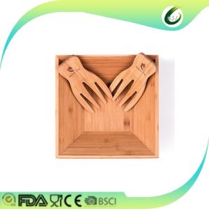 big bamboo salad and fruit bowl with hand servers