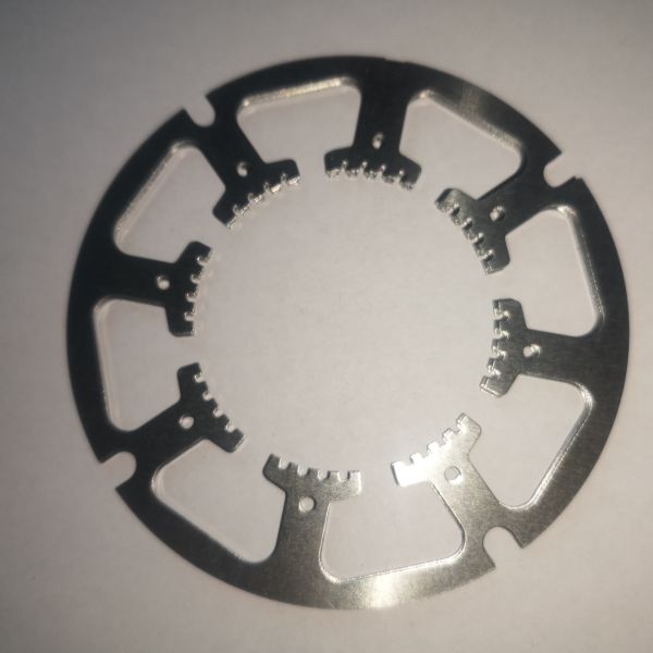 Precision motor encoder disc showing detailed metal pattern and construction