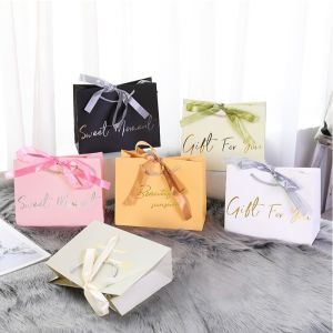 China Shopping Boutique Paper Gift Bags 300gsm With Bronzing Printed Logo Ribbon Handle on sale